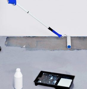Worker paint with primer concrete floor for waterproofing